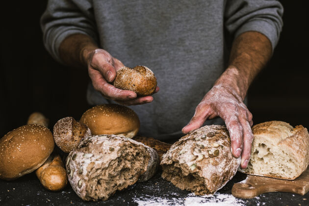食物面包师手里拿着一块乡村有机面包面包糕点面包师