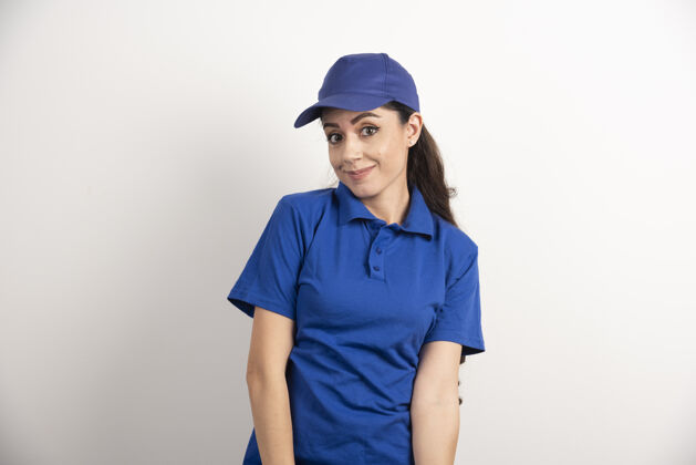 成人穿着蓝色制服的漂亮女人用手触摸她的脸高质量的照片服务女士工人
