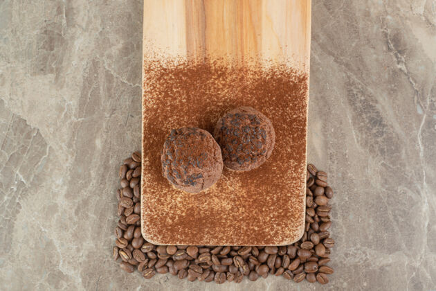 饼干两块巧克力饼干放在木盘上 上面放着咖啡豆可可咖啡豆糕点