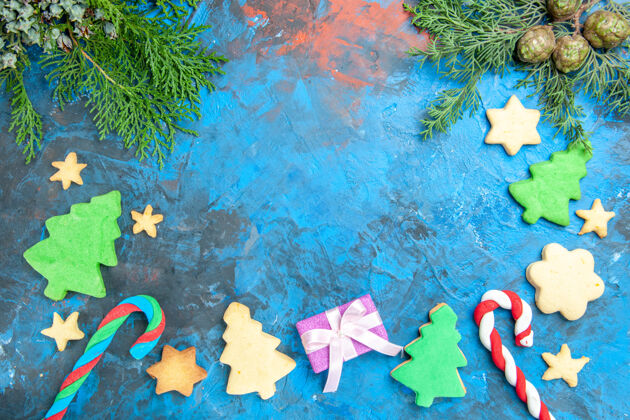 垃圾蓝色表面上有礼物的小树的俯视图圣诞现在纹理