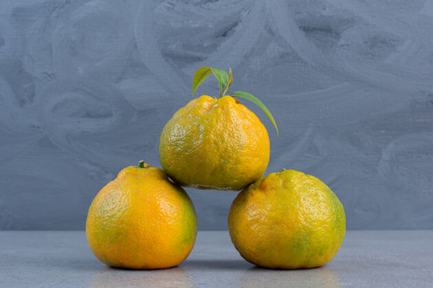 美味大理石背景上陈列着一束多汁的橘子橘子营养水果