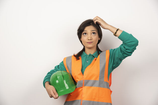 女性女工程师抓着头 拿着白色背景的头盔工人建筑建筑师