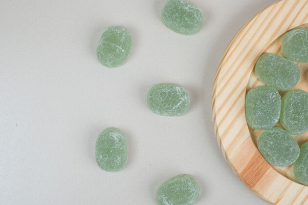 邦邦木头盘子上的绿色糖果果酱甜点零食