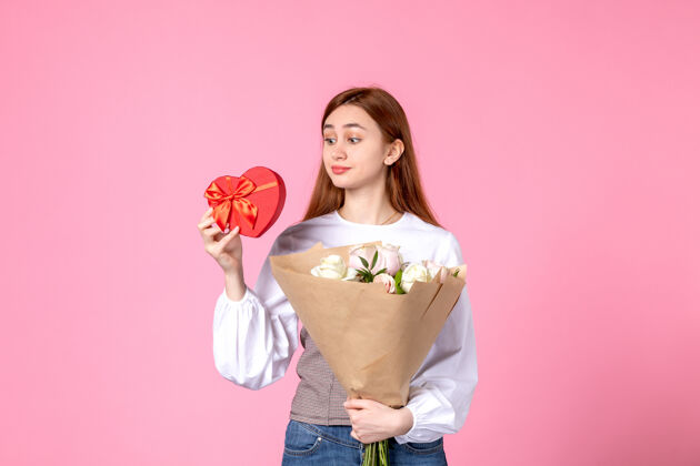人正面图：年轻女性 带鲜花 作为女性节礼物 粉色背景 水平三月 女性约会 玫瑰 爱情 性感 女性化花年轻女性玫瑰