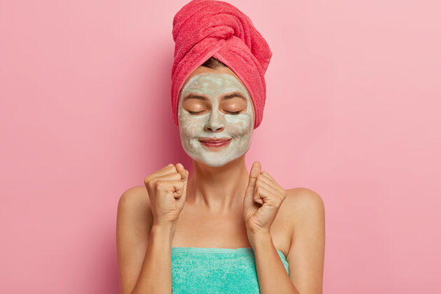 化妆品满意的女性模特紧握拳头 用毛巾包好面膜后刺激血液循环 洗澡后或沐浴面膜定期清洁面部润肤霜治疗室内