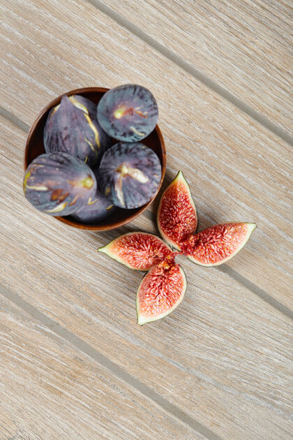 生一碗黑色无花果和无花果片放在木桌上盘子美味水果
