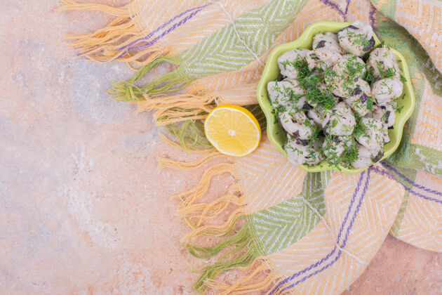 餐具高加索人钦卡利面团在一个绿色的盘子与草药和柠檬早午餐柑橘晚餐