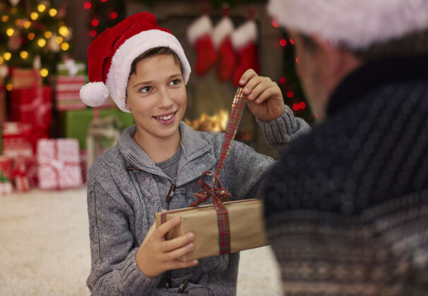 地毯圣诞气氛中的父子俩丰富礼品盒男孩