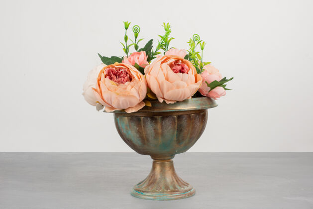 盛开美丽的粉红玫瑰花瓶在灰色的表面自然花花束