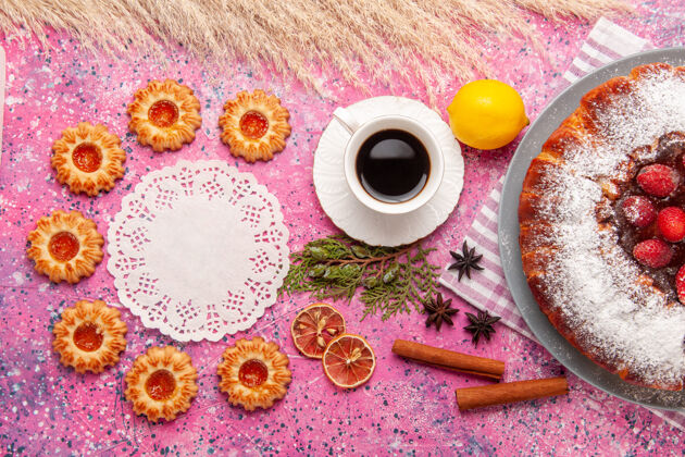 饼干顶视图美味草莓蛋糕糖饼干柠檬和茶粉上的粉红色背景蛋糕甜糖饼干饼干茶彩色蛋糕饼干
