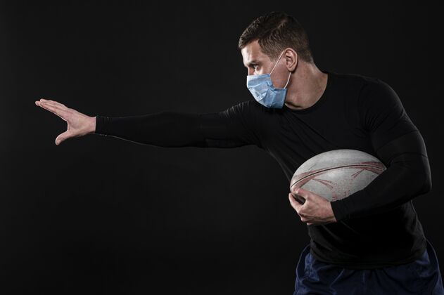 医疗面具侧视图男性橄榄球运动员与医疗面具和球锦标赛竞技完全