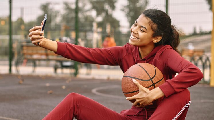 球拿着篮球自拍的女人运动装运动女子