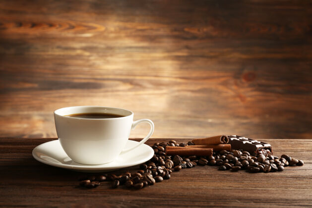 乡村一杯咖啡加上谷物 巧克力和肉桂棒放在木桌上咖啡东西马克杯