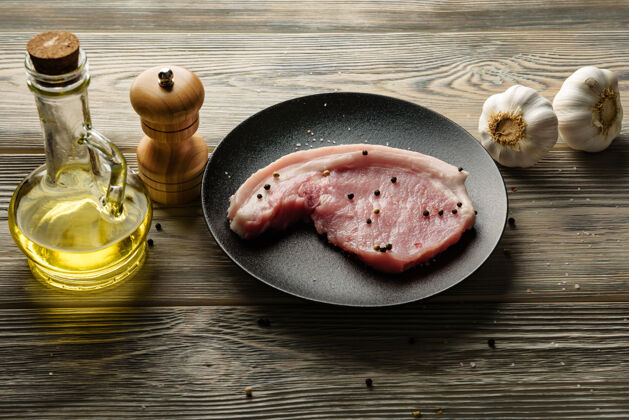 肉一块猪肉 橄榄油和大蒜放在木桌上食物食谱块