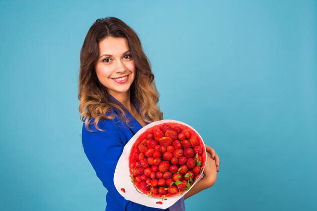 有机拿着一束草莓的年轻女人食品礼品植物
