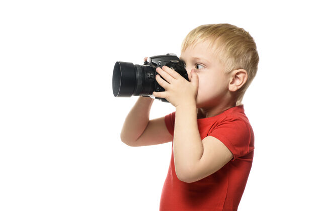 小年轻的金发男孩照相机.肖像 白色隔离背景侧查看人表情可爱