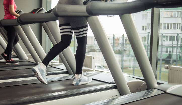 跑步健康的生活方式概念女性在健身房的跑步机上跑步活动健康设备