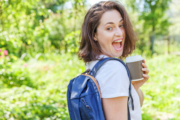 旅行快乐积极的女学生 背着背包 在绿色公园的背景下微笑着人学习举行