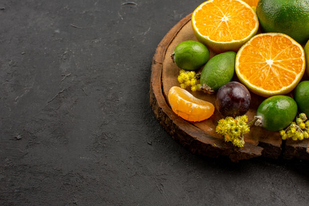 食品前视新鲜的绿色橘子和黑桌子上的异国情调的水果绿色柑橘酸新鲜酸味水果肥肉