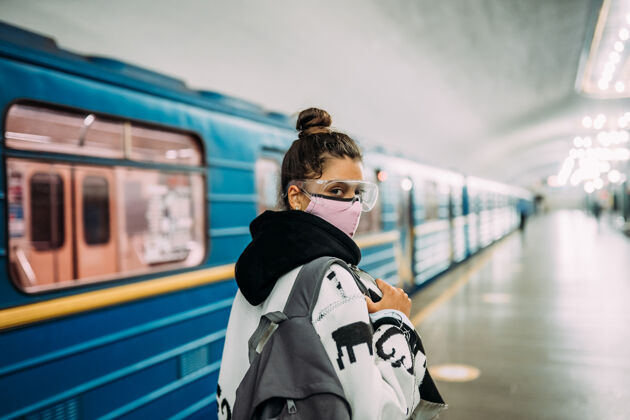 预防戴着医用防护面罩站在车站的年轻女子呼吸车站肺炎