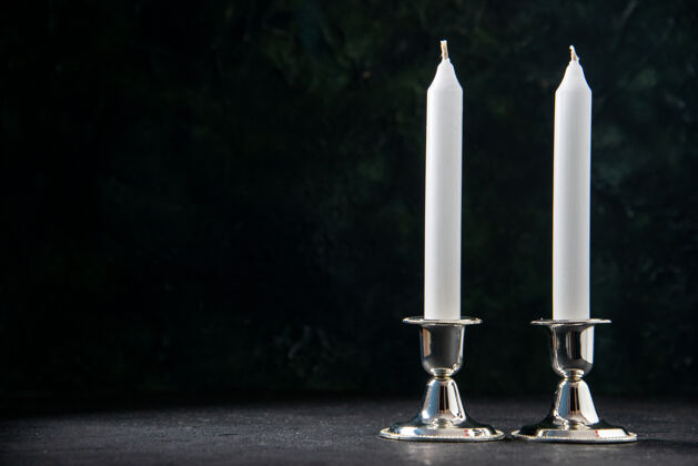 宗教黑色墙壁上白色长蜡烛的正视图死亡象征纪念