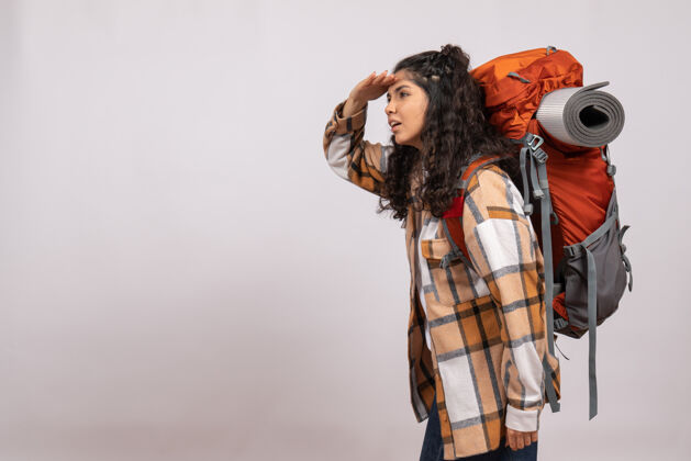 年轻女性前景年轻女子背着背包远足在白色背景上遥望远方校园旅游度假山间森林空气之旅空气山背包