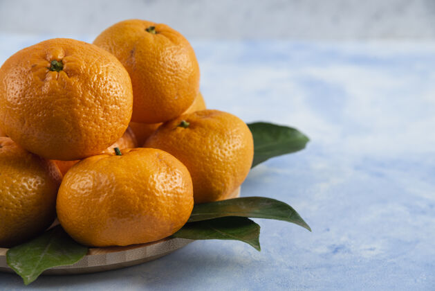 群体新鲜柑橘和树叶的特写镜头香气季节木板