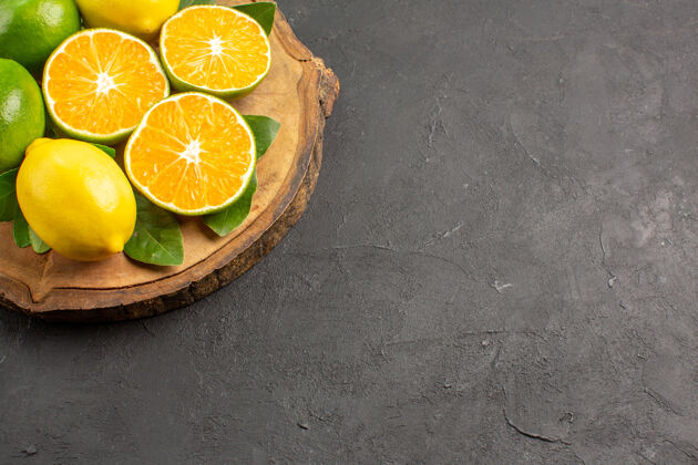健康前视图新鲜的酸柠檬在黑暗的地板树上酸橙水果柑橘前树可食用水果