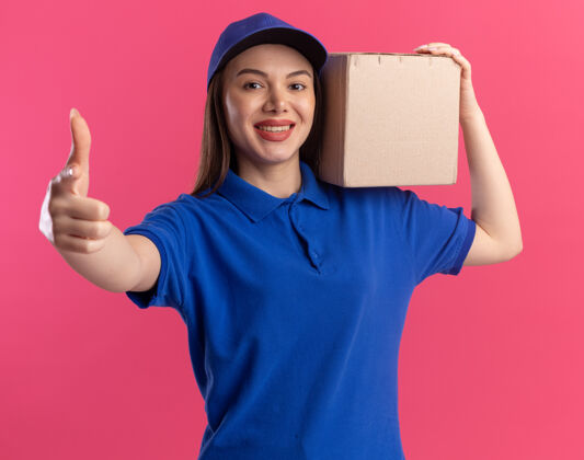制服微笑着的漂亮送货员 穿着制服 竖起大拇指 肩上扛着粉色的名片盒漂亮粉色女人