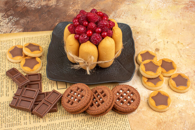 饮食美味蛋糕的侧视图不同的饼干放在棕色盘子上的混色桌上水果甜点混合