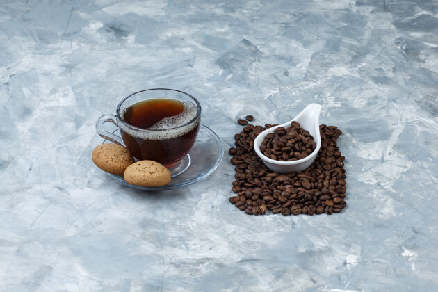 种子一套饼干 一杯咖啡和咖啡豆放在一个白色瓷罐里早晨热的拿铁