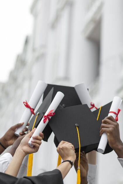 大学把拿着文凭和帽子的手收起来教育特写青年