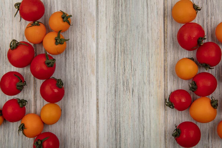 有机顶视图有机红色和橙色西红柿隔离在灰色木墙上与复制空间新鲜景观农业
