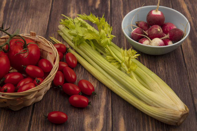 农业健康的西红柿放在桶上 萝卜放在碗上 芹菜放在木墙上木材食品桶