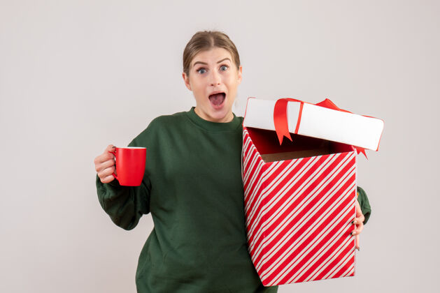 茶前视图年轻女性 圣诞礼物和一杯茶情感礼物颜色