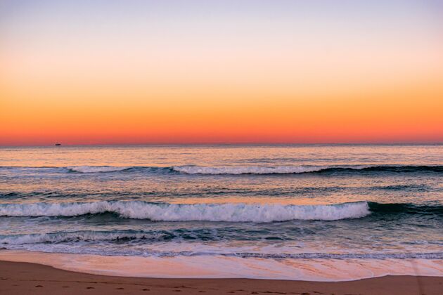 蓝色在海滩上欣赏迷人的日落美景彩色海洋地平线