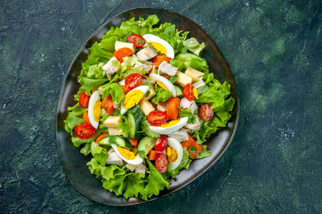 一餐俯瞰自制美味沙拉在一个绿色黑色混合色背景与自由空间黑色盘子顶部健康蔬菜