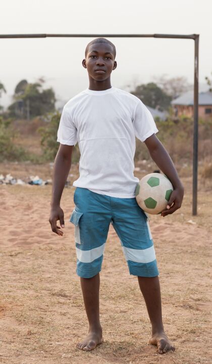 非洲一个拿着足球的非洲小孩玩足球比赛孩子