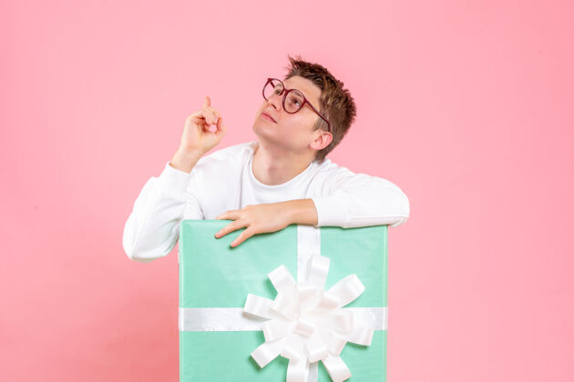 睡衣正面图：穿着白色衬衫的年轻男性 粉色背景上有礼物风景指点圣诞
