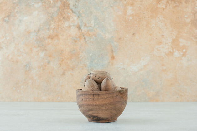 健康白色背景上的一小碗坚果高质量的照片木头棕色坚果