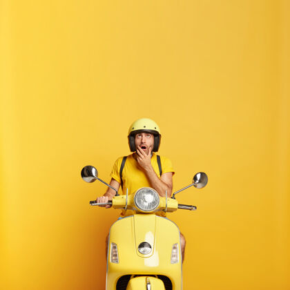 快递一个戴着头盔的家伙开着黄色的摩托车汽车目的地摩托车