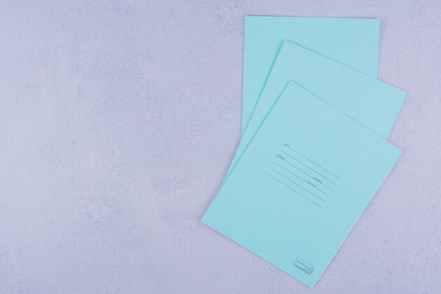 教育蓝色的笔记本孤立在灰色的表面上工作工具简约