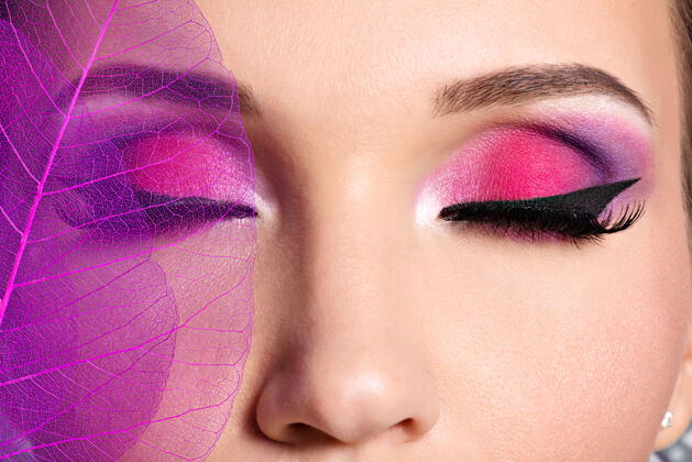 艺术家用漂亮时尚的亮粉色妆容特写女性眼睛化妆品魅力制作
