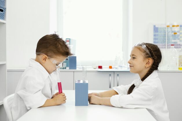 实验实验室里戴着安全眼镜的男女科学家的侧视图水平试管女孩