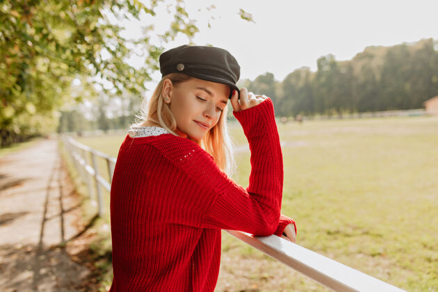 帽子美丽的金发模特在阳光明媚的秋天感觉平静年轻女子戴着时髦的帽子和漂亮的配饰裙子快乐漂亮