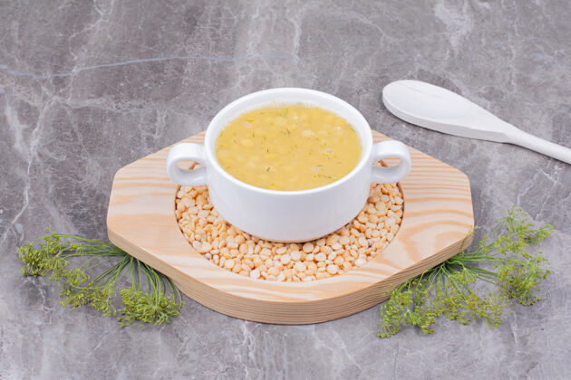 新鲜一杯白豌豆汤放在木盘上传统晚餐大理石