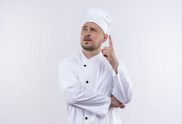 体贴体贴的年轻帅哥厨师身着厨师制服 抬起手指望着与世隔绝的白色空间手指厨师英俊