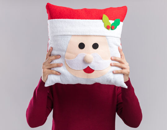 圣诞节戴着圣诞帽戴着眼镜的年轻人 脸上戴着圣诞枕头 背景是白色的封面男人枕头