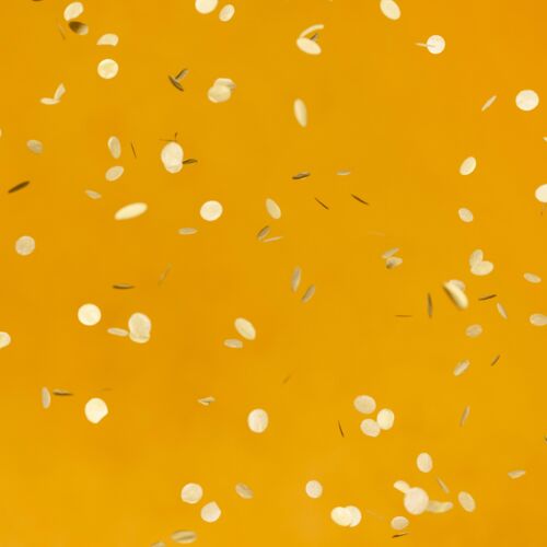 周年纪念橙色墙上金色派对五彩纸屑的排列活动节日庆祝